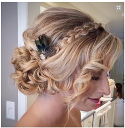 Side swept loose bun with braid and embellished with hair accessory