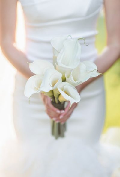 A formal posy of elegant white calla lilies created by Clarendon Hills